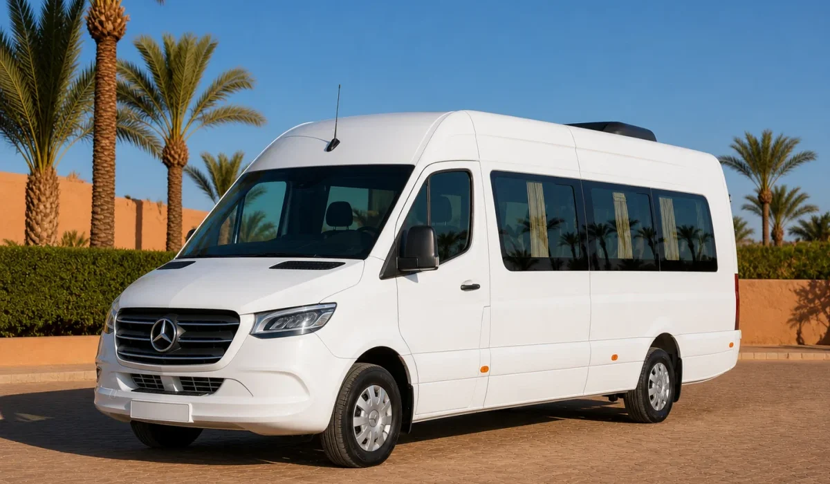 Pristine white Mercedes Sprinter passenger minibus in a palm-lined Marrakech fleet yard