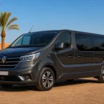Pristine graphite Renault Trafic passenger minibus in a palm-lined Marrakech fleet yard