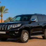 Pristine black Toyota Land Cruiser Prado 4x4 in a palm-lined Marrakech fleet yard
